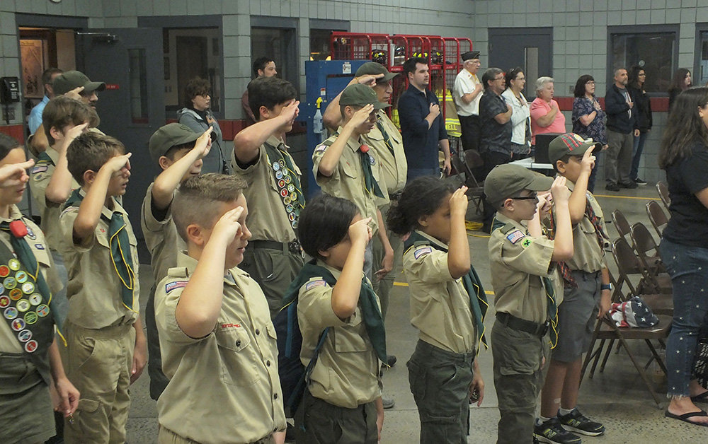 Local scouts salute during the Pledge of Allegiance.